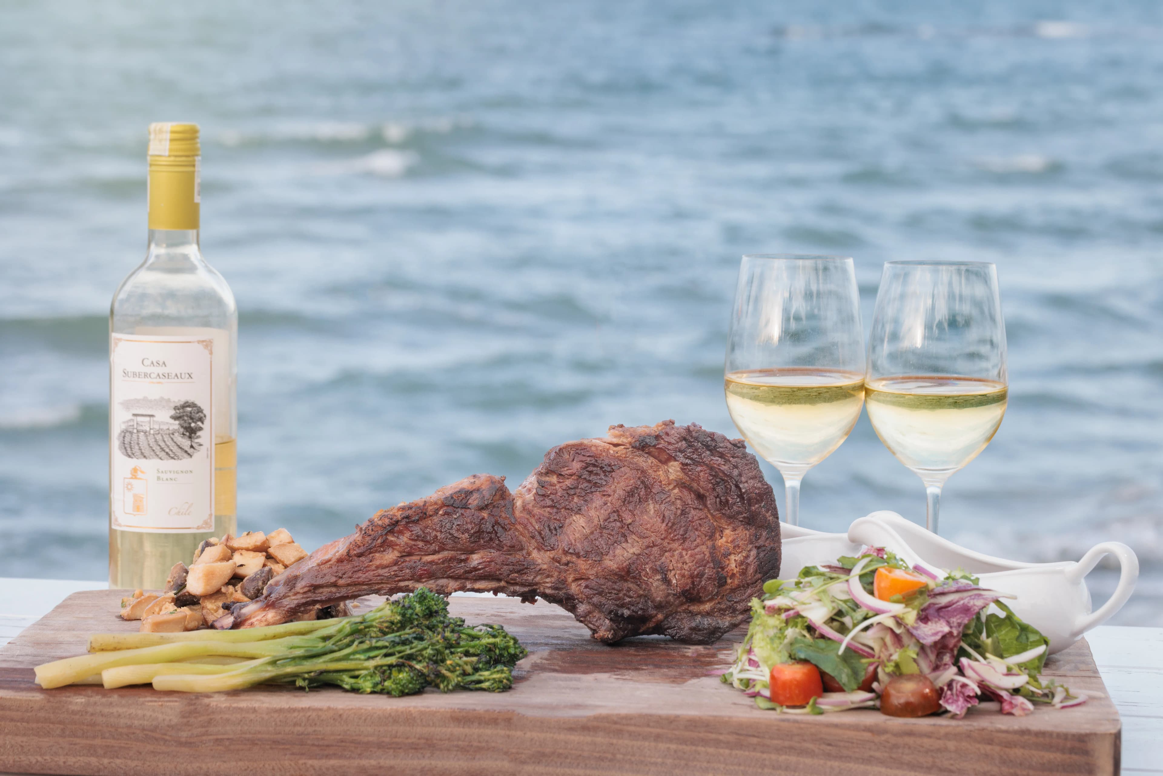 T-Bone steak with fries and white wine