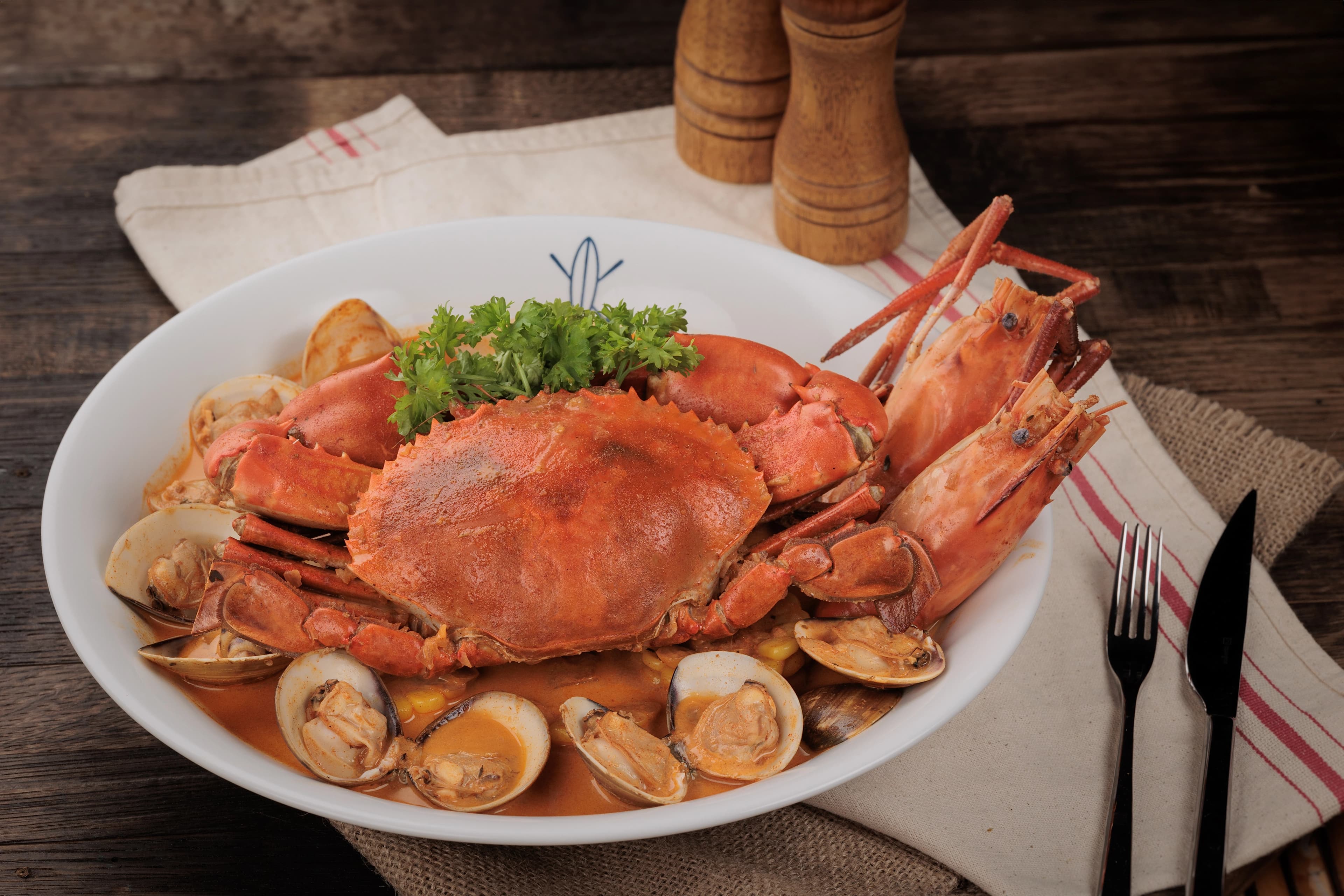 Cajun style seafood combo with crab, lobster, shrimp, and clams